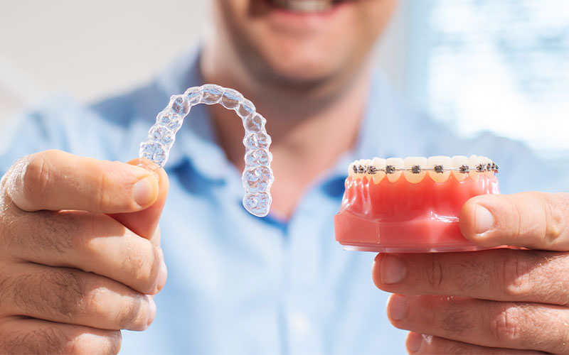 Griesbach Dental - Dentist holding both Braces and Invisalign