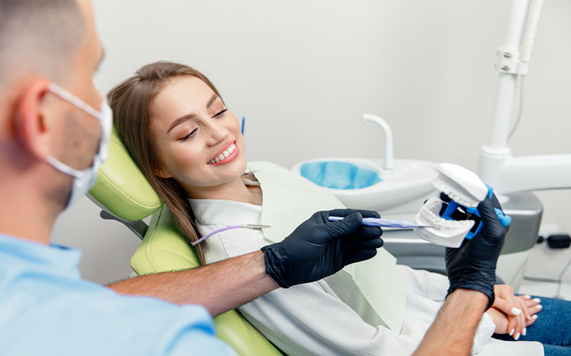 Griesbach Dental - Dentist talking to their patient about tooth decay