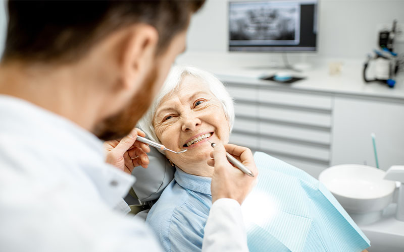 Griesbach Dental - Dentist talking to their patient about dental implants